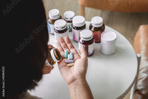 closeup woman taking mutivitamins hand holding supplement pills