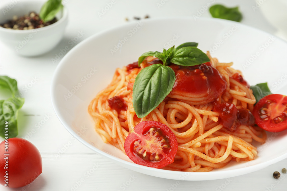 Delicious pasta with tomato sauce, peppercorns, vegetables and basil on white wooden table, closeup Delicious pasta with tomato sauce, peppercorns, vegetables and basil on white wooden table, closeup