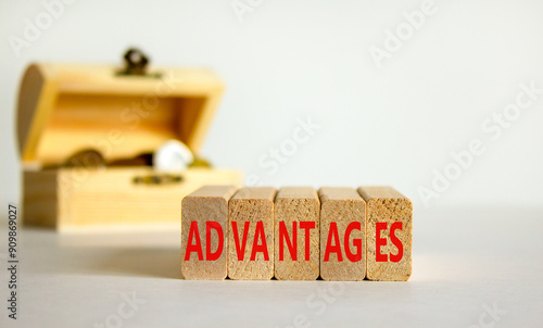 Advantages symbol. Concept word Advantages on beautiful wooden blocks. Beautiful white background. Beautiful wooden chest with coins. Business advantages concept. Copy space.
