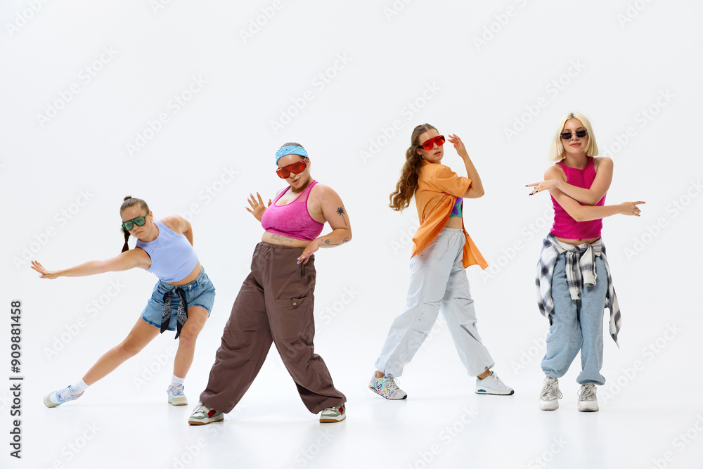 Naklejka premium Diverse group of four dancers in vibrant streetwear and sunglasses pose energetically, expressing unique styles and synchronized movements. Concept of music, fashion and art, retro and modernity. Ad