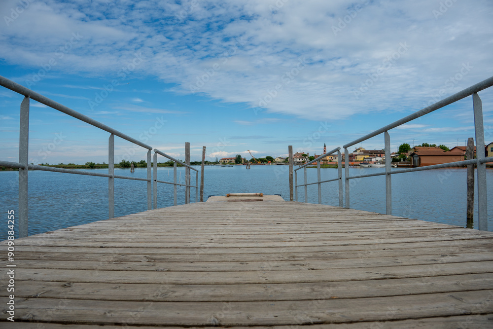 Wooden Dock Leading to Peaceful Waterfront Village Wooden Dock Leading to Peaceful Waterfront Village