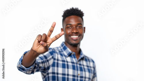 An african man doing the victory sign to the camera on a isolated white background