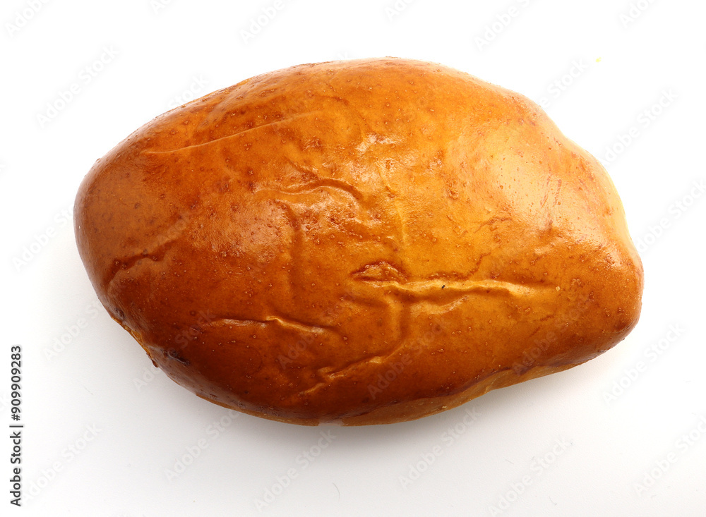 Freshly baked golden brown bun with a crispy outer layer. Close-up photo. Freshly baked golden brown bun with a crispy outer layer. Close-up photo.
