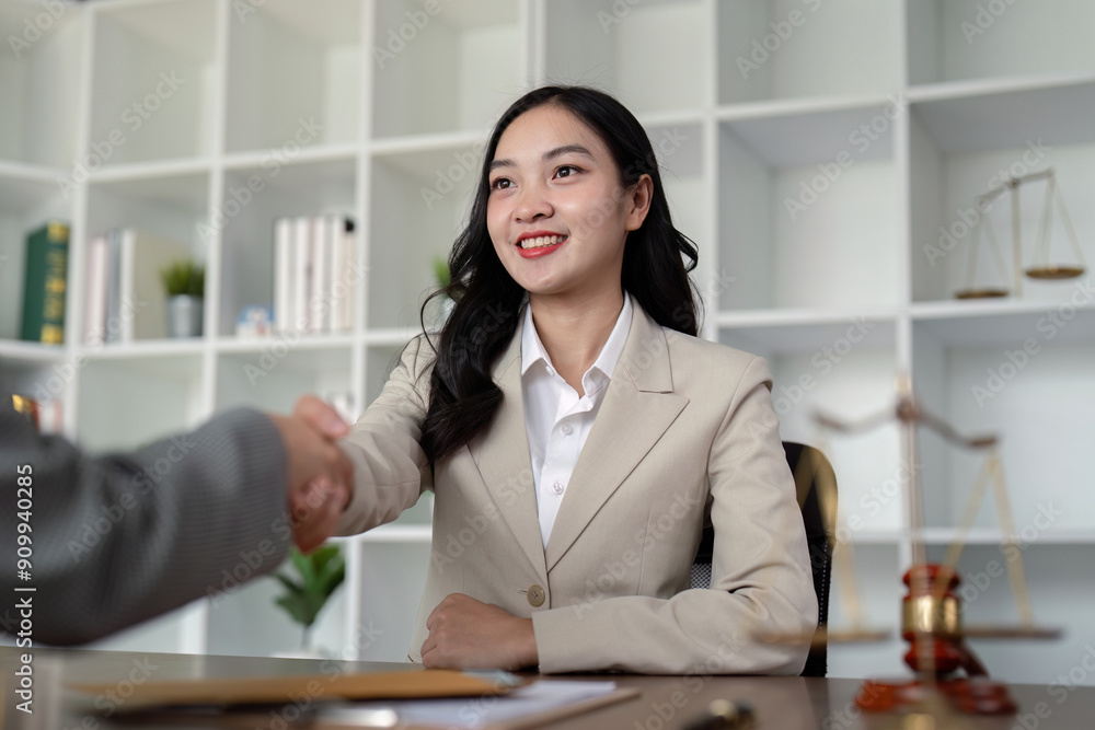 Confident Female Lawyer Shaking Hands with Client in Modern Office Setting, Symbolizing Professional Agreement and Trust Confident Female Lawyer Shaking Hands with Client in Modern Office Setting, Symbolizing Professional Agreement and Trust