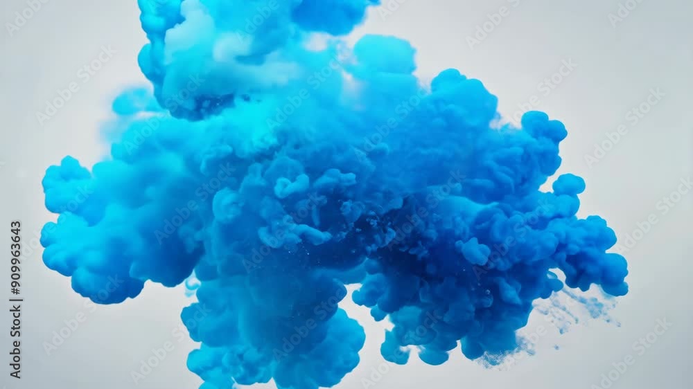 Blue Smoke Cloud During Daytime Outdoor Event. A vibrant blue smoke cloud rises into the sky, creating a striking visual effect during an outdoor activity.