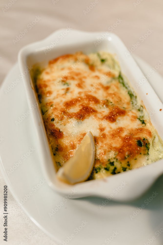 delicious casserole with fresh vegetables and aromatic herbs on a beautiful white plate in a cozy and nice restaurant delicious casserole with fresh vegetables and aromatic herbs on a beautiful white plate in a cozy and nice restaurant
