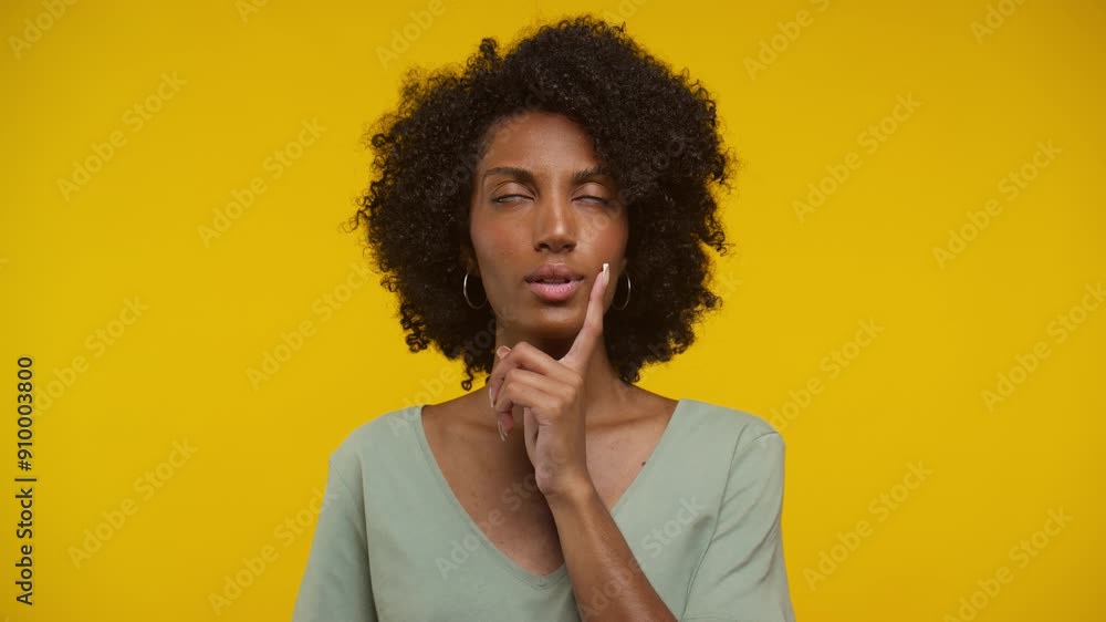 Woman with Curly Hair Thinking on Yellow Background Woman with Curly Hair Thinking on Yellow Background