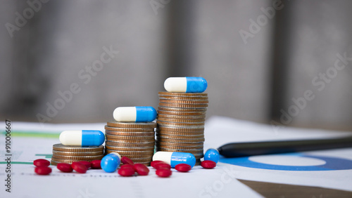 Blue and white capsules on a pile of coins and pills, meaning health insurance, medical expenses and pharmaceutical, finance, saving money, business, financial and medical healthcare concept.