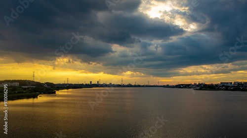 Hyperlapse showing the contrast between rain clouds and the setting sun at Lake Teganuma, Abiko City, Chiba Prefecture Japan photo