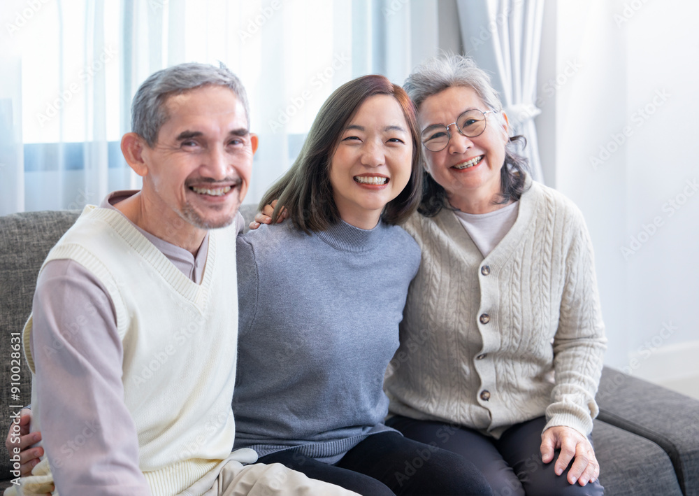 portrait happy asian family enjoy leisure time in the living room together,sitting on sofa,hugging and posing to camera,concept of family lifestyle,relationship,domestic life portrait happy asian family enjoy leisure time in the living room together,sitting on sofa,hugging and posing to camera,concept of family lifestyle,relationship,domestic life