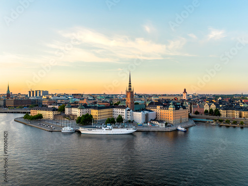 Aerial view of Gamla Stan, old town in Stockholm, Sweden in sunset with Riddarholmskyrkan church in foreground and a colorful clear sky background