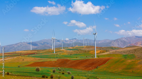 Wildmill standing on the field at mountain in blue sky