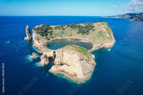 Aerial view of Ilheu de Vila Franco do Campo on a bright summer day, showcasing its turquoise lagoon and volcanic beauty off Sao Miguel, Azores, Portugal photo