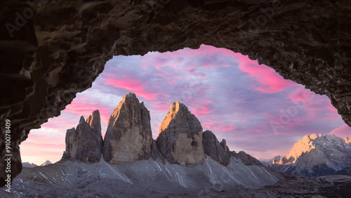 Panoramic view from the cave on Tre Cime Di Lavaredo peaks in incredible purple sunrise light. Three peaks of Lavaredo, Dolomite Alps, Italy, Europe. Landscape photography