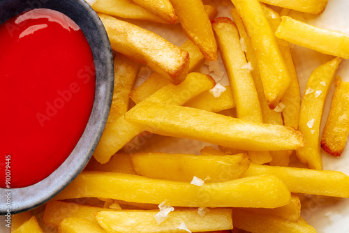 French fries with tomato sauce, a close-up of delicious potato chips