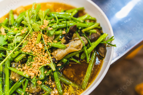 Stir fried water spinach with snails served in dish isolated on grey background top view of seafood photo