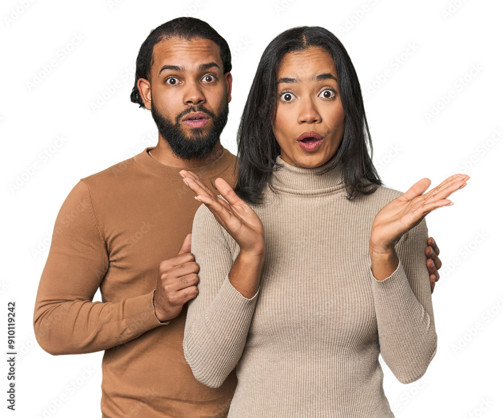 Fototapeta premium Young Latino couple in studio surprised and shocked.