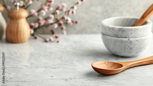 Wooden Spoon Beside Marble Bowl on Gray Cloth Set Against Smooth Surface