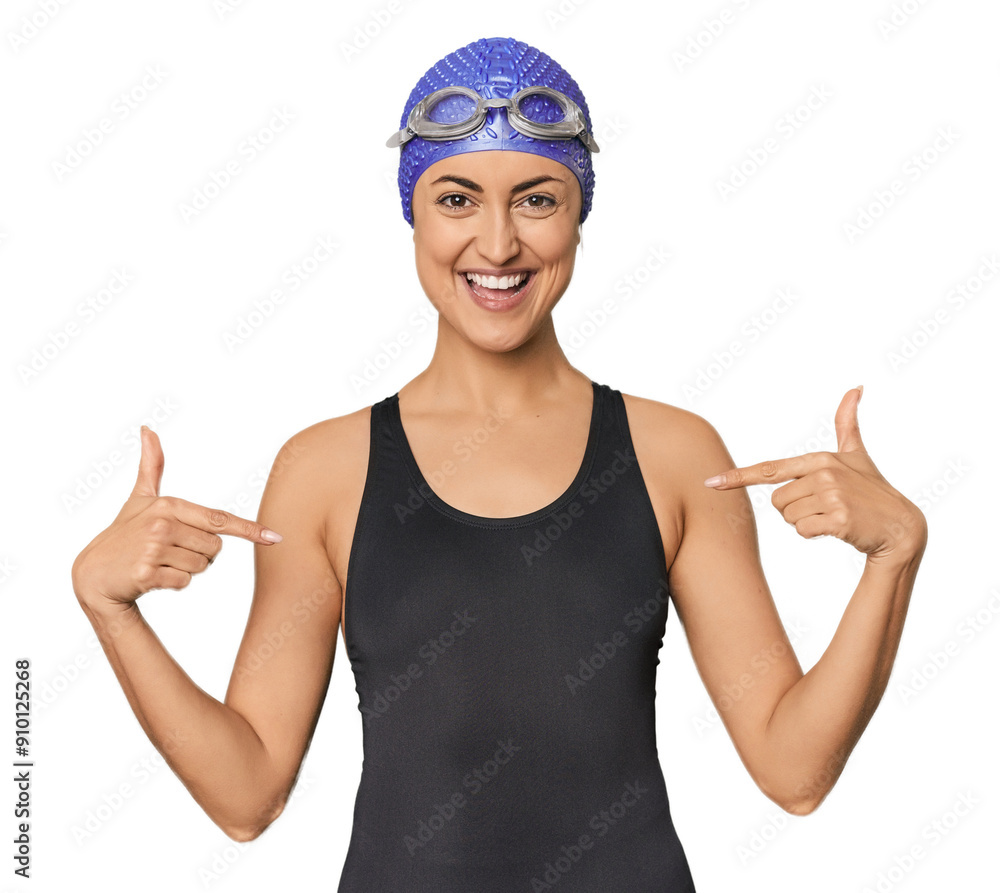 Young Caucasian female professional swimmer surprised pointing with finger, smiling broadly. Young Caucasian female professional swimmer surprised pointing with finger, smiling broadly.