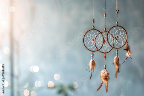 A minimal background with elegant boho-style dreamcatchers hanging against a neutral backdrop photo