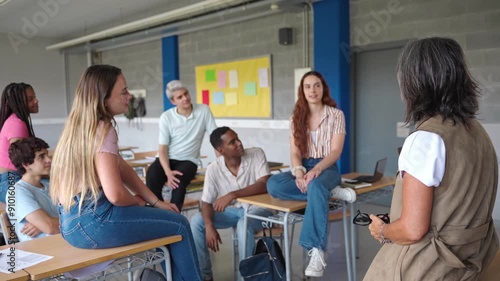 Teenager High School students talking to senior tutor teacher - Group support conversation in Higher Education
