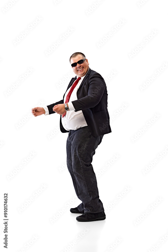 Taking dynamic break. Overweight man in black suit, white shirt and sunglasses, employee dancing, relaxing isolated on white background. Concept of business, leisure, achievement Taking dynamic break. Overweight man in black suit, white shirt and sunglasses, employee dancing, relaxing isolated on white background. Concept of business, leisure, achievement