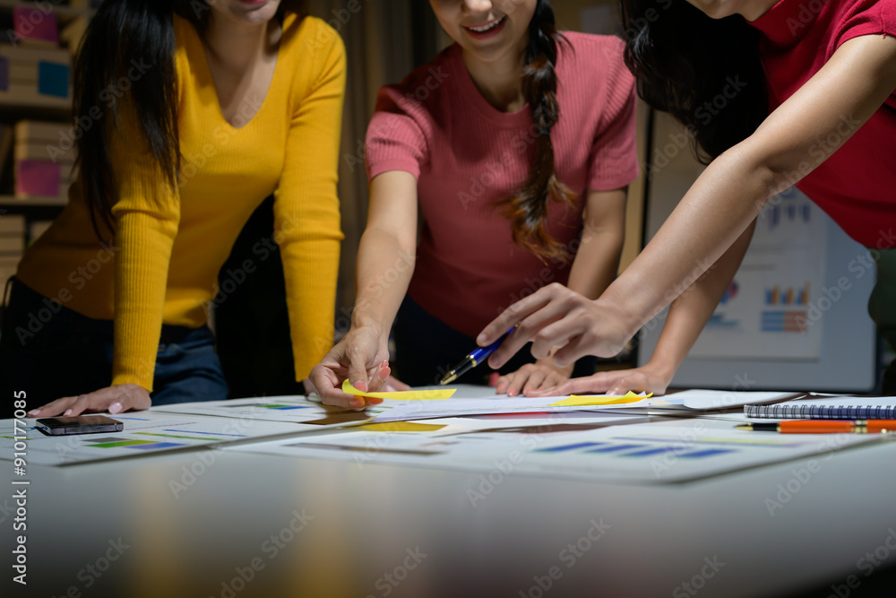 Fototapeta premium Team of Young Professionals Collaborating on Project in Modern Office Environment