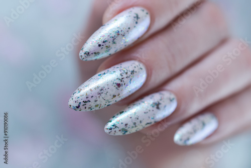 beautiful female hands with long nails light white and green manicure