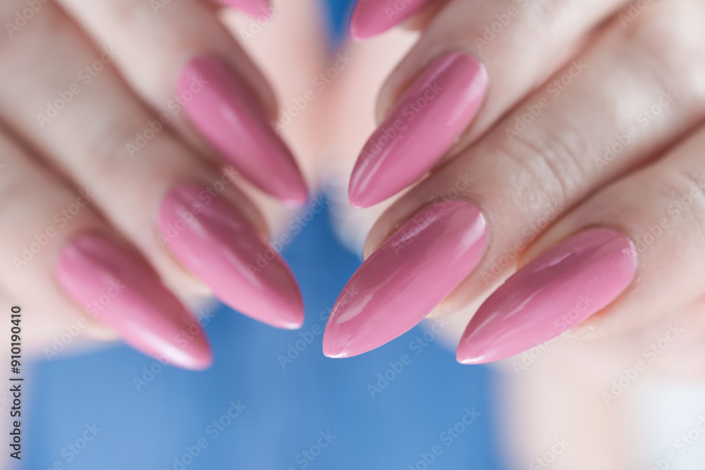 Woman hand with long nails manicure and light pink nail polish Woman hand with long nails manicure and light pink nail polish