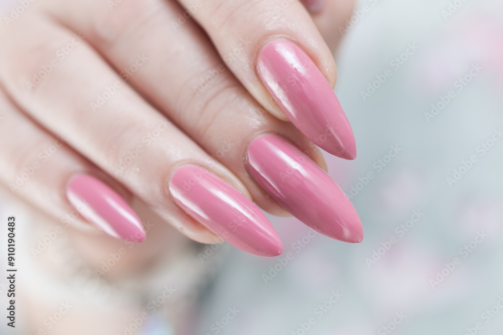 Woman hand with long nails manicure and light pink nail polish Woman hand with long nails manicure and light pink nail polish