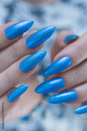 Female hand with long nails and light blue manicure