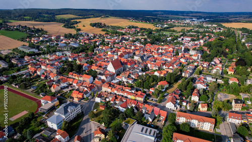 A panorama Aerial view around the old town of the city Neustadt an der Orla on an early summer day in Germany.