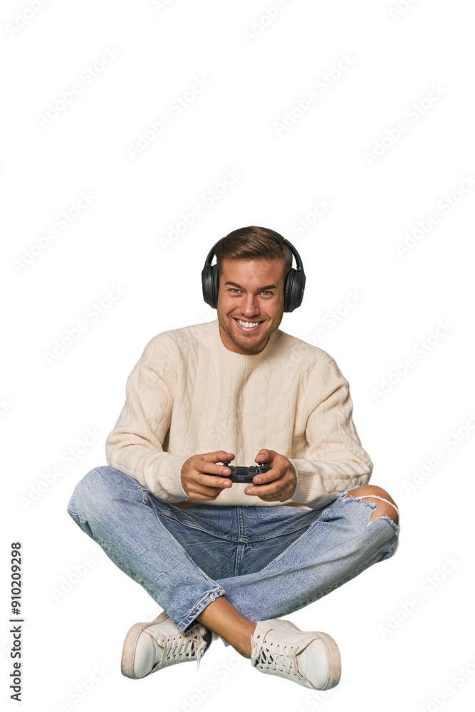 Young man playing video games with a controller on studio floor Young man playing video games with a controller on studio floor