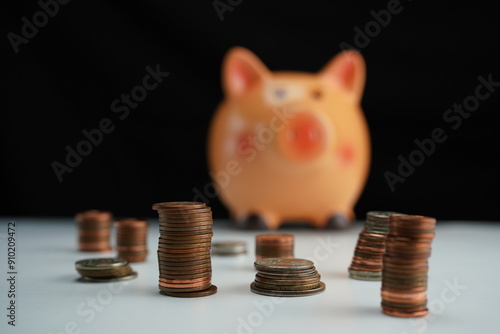 Wallpaper Mural several piles of coins of different currencies in front of a piggy bank in the background in blur as a savings concept Torontodigital.ca
