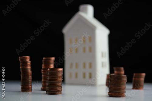Wallpaper Mural Horizontal photo of stacked coins of different currencies in front of a house as a concept of saving for home purchase Torontodigital.ca