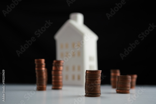 Wallpaper Mural Stacked coins of different currencies in front of a house as a concept of saving for home purchase Torontodigital.ca