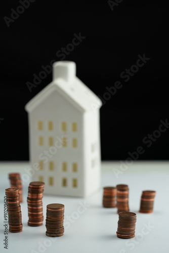 Wallpaper Mural Vertical photo of stacked coins of different currencies in front of a house as a concept of saving for home purchase Torontodigital.ca