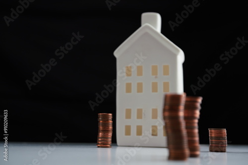 Wallpaper Mural General view with left air of the image of stacked coins of different currencies in front of a house as a concept of saving for home purchase Torontodigital.ca