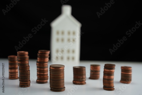 Wallpaper Mural piles of coins in front of a house as a concept of saving for the purchase of a home Torontodigital.ca