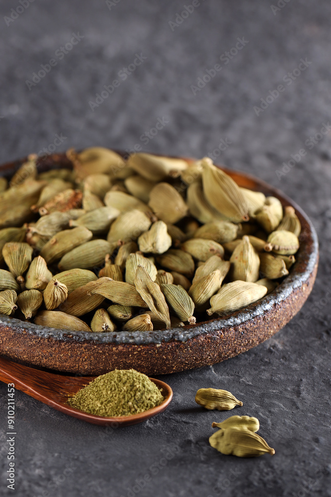 organic cardamom spice in bowl on table organic cardamom spice in bowl on table