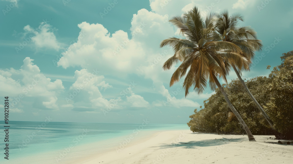 Obraz premium Palm trees arch over a tranquil, pristine beach with soft white sand, facing a gentle ocean under a sky filled with fluffy clouds.
