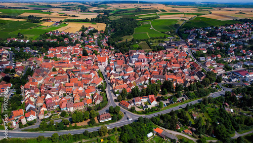 An Aerial panoramic view of the old town of the city Dettelbach on a sunny day in Germany.	 photo