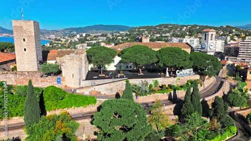 Aerial view of Cannes Port on the French Riviera, Cote d'Azur. Sign Cannes written with light bulbs on a top of a mountain in the Notre Dame d'Esperance church.