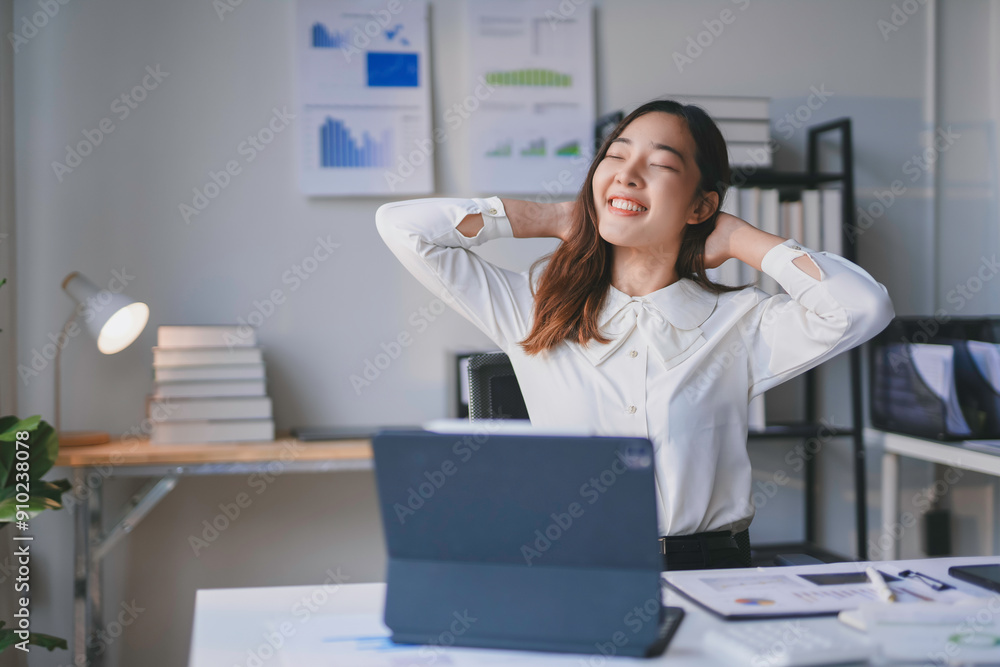 Office worker is taking a break from work to relieve stress by stretching her neck Office worker is taking a break from work to relieve stress by stretching her neck