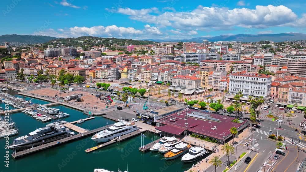 Aerial view of Cannes Port on Cote d'Azur, France. View from above of Marina port with ships and yachts in a resort town on the French Riviera, famed for its international film festival. Aerial view of Cannes Port on Cote d'Azur, France. View from above of Marina port with ships and yachts in a resort town on the French Riviera, famed for its international film festival.