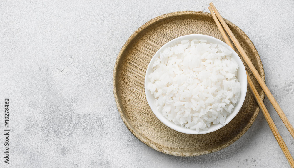 Bowl of steamed white rice with chopsticks on concrete table. Tasty Asian food. Healthy nutrition Bowl of steamed white rice with chopsticks on concrete table. Tasty Asian food. Healthy nutrition