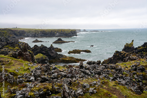 Basaltic cliffs at the shore of Iceland with waves and rough seas