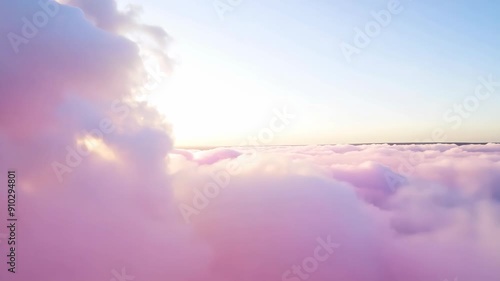 Flying through fluffy pink clouds in sky. Scenic aerial view. Tranquil sky and sugar cotton cloudscape concept. Dreamy and ethereal