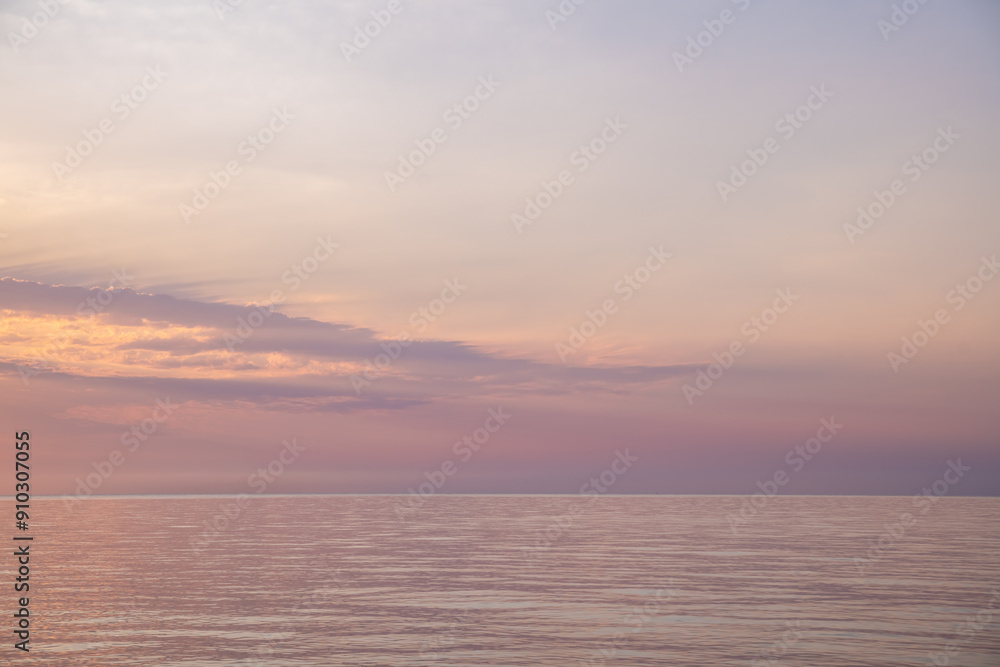 Fototapeta premium Beautiful gentle and delicate pink sunrise on the sea, sky with clouds, natural delicate background