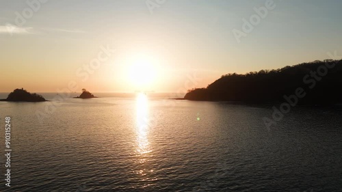 Yates yendo a ver la puesta del sol en medio de islotes en el oceano pacifico de Costa Rica photo